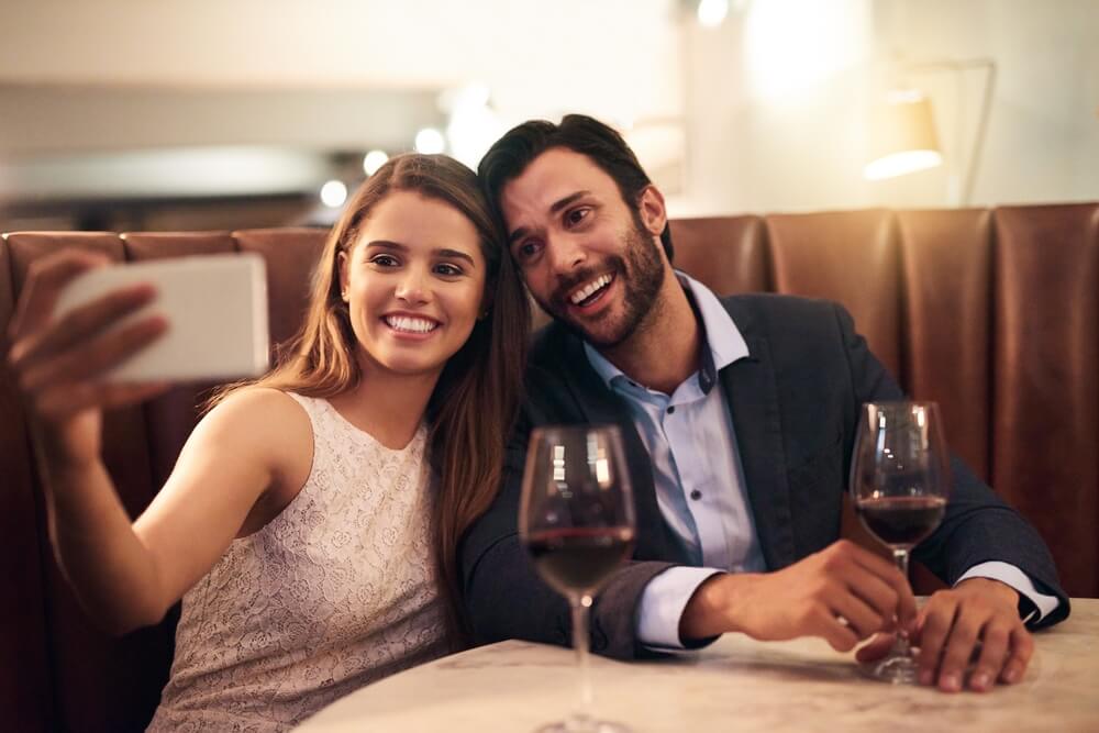 A couple talking a picture at a fine dining restaurant in Naples, Florida.