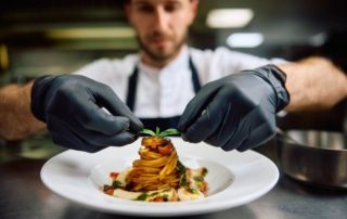 A chef plating up a dish at one of the best downtown Naples restaurants.